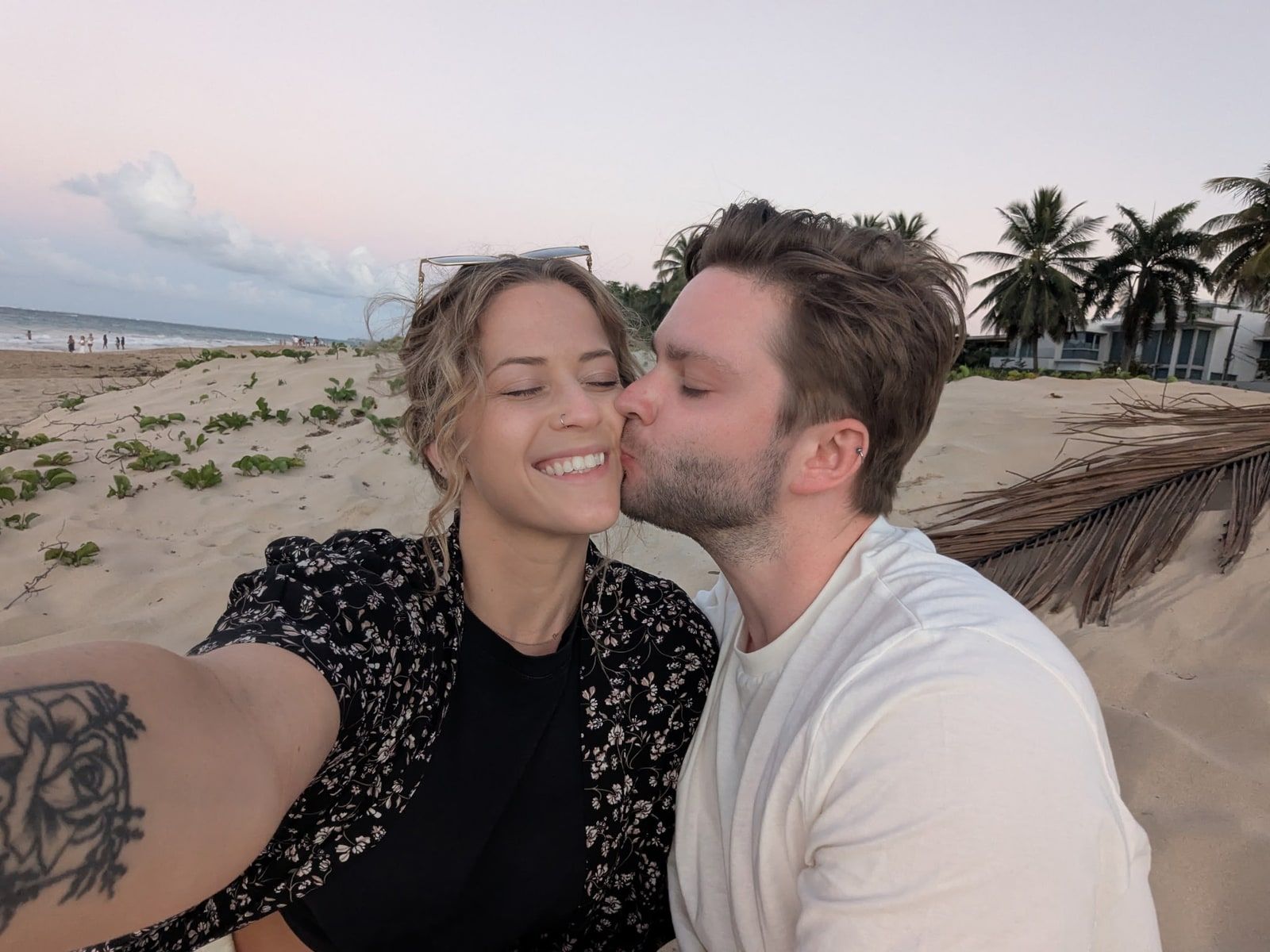JohnLuc kissing Katelyn on the cheek at the beach.